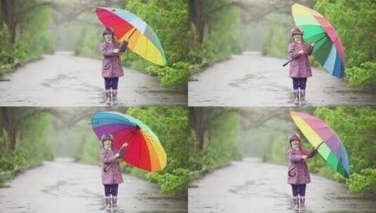 手里拿着雨伞的小女孩在雨中跳跃高清在线视频素材下载