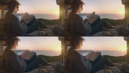 女人在海边的美丽风景下阅读高清在线视频素材下载