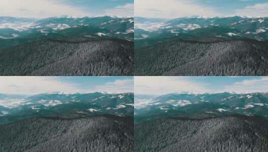 飞过白雪覆盖的森林和群山景观高清在线视频素材下载