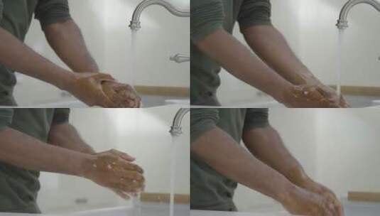 男人在水龙头下用肥皂水洗手高清在线视频素材下载