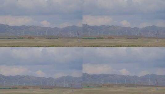 新疆天山脚下草原上的风车/风力发电机高清在线视频素材下载