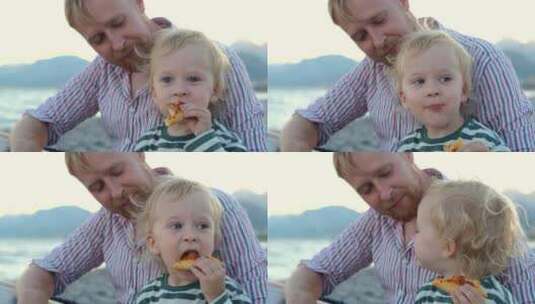 肖像儿子和父亲在海滩上吃披萨高清在线视频素材下载