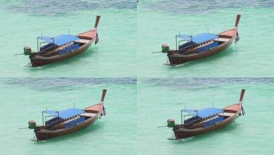 长尾船漂浮在海滩附近的海里。泰国长尾船。高清在线视频素材下载