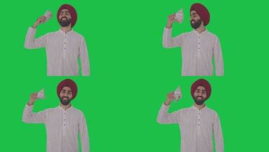 快乐的锡克教印度人用钱当粉丝绿屏高清在线视频素材下载