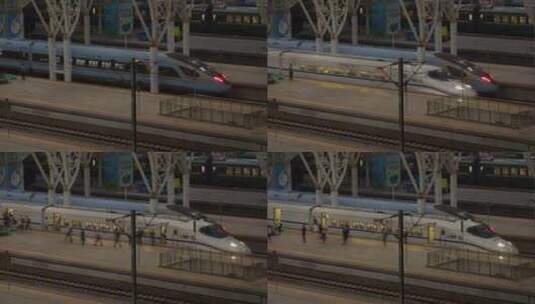 夜晚南京站内，一列和谐号列车到站停车下客高清在线视频素材下载