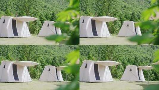 航拍阳光下草地上露营地帐篷高清在线视频素材下载
