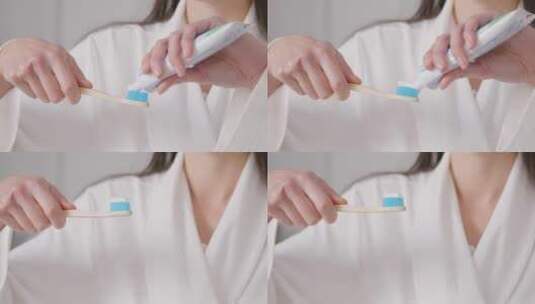 在牙刷上涂牙膏的女人高清在线视频素材下载