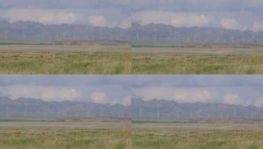 新疆天山脚下草原上的风车/风力发电机高清在线视频素材下载