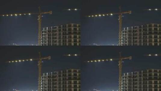 夜间建筑施工.延时摄影.带照明的建筑工地塔式起重机高清在线视频素材下载