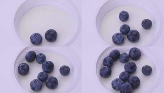 白背景酸奶俯拍特写倒蓝莓固定高清在线视频素材下载