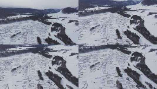 航拍冬季新疆阿勒泰禾木雪景雪山森林村落高清在线视频素材下载