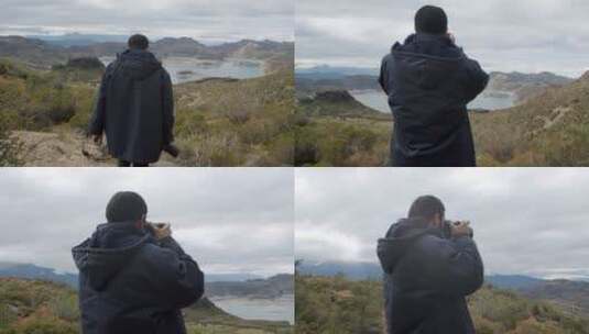 男人在山上用单反相机拍照高清在线视频素材下载