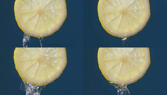 蓝色背景下水滴透过柠檬片高清在线视频素材下载