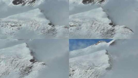 航拍半俯瞰雪山峰云海交界处高清在线视频素材下载