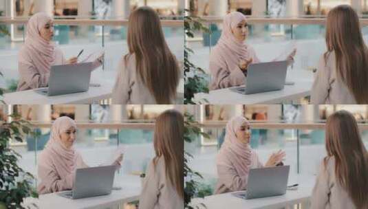 两个年轻女孩坐在餐桌旁友好的穆斯林女性财高清在线视频素材下载