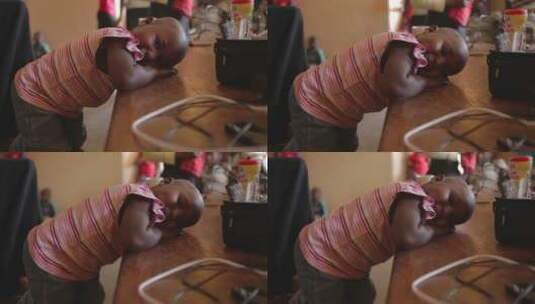 非洲女孩把头放在桌子上高清在线视频素材下载