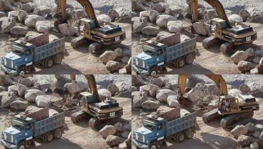 挖掘机将岩石吊人卡车高清在线视频素材下载