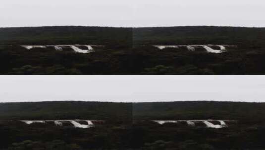 竖屏拍摄远方的瀑布景观高清在线视频素材下载