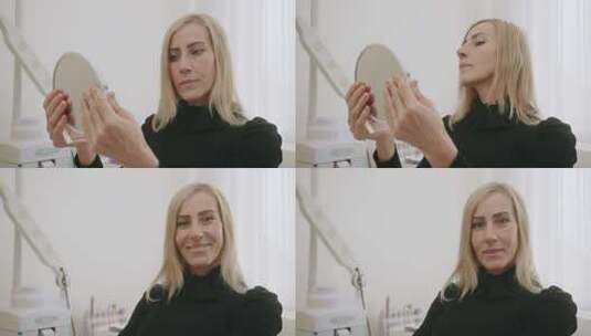 女人拿着镜子检查皮肤高清在线视频素材下载