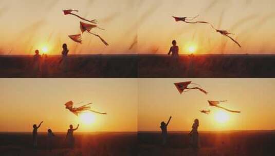 日落时分兄弟姐妹玩玩具风筝的剪影高清在线视频素材下载