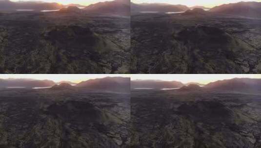 日落时贫瘠的景色中湖边的火山山脉视频高清在线视频素材下载