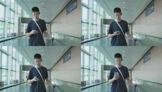 男孩子暑假出行在机场用手机高清在线视频素材下载