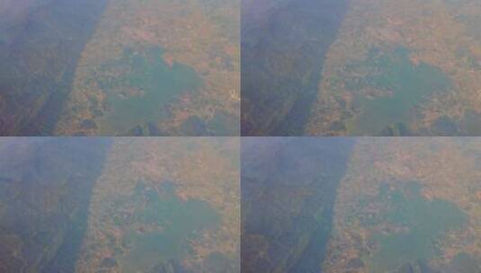 飞机窗外的陆地山脉湖泊高清在线视频素材下载