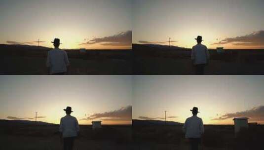 戴帽子的男人走向太阳剪影高清在线视频素材下载