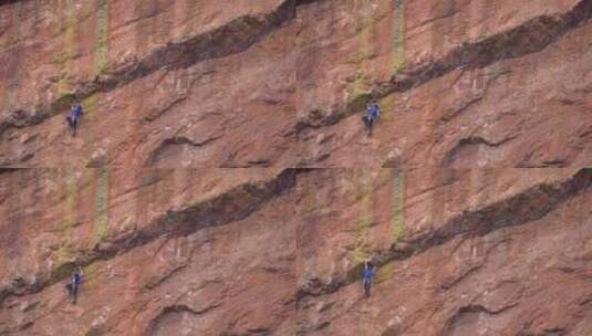 攀岩爱好者攀爬悬崖峭壁高清在线视频素材下载