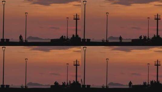 夕阳下海滩码头上的行人高清在线视频素材下载