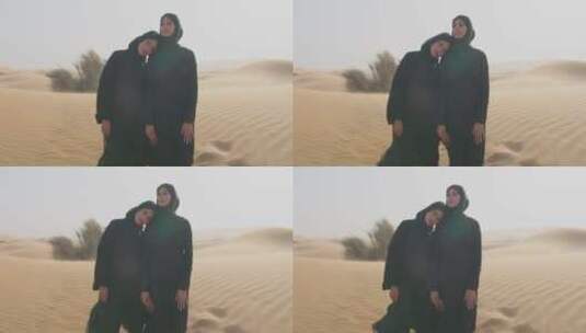 两个穿着黑色衣服的女人站在沙漠里拥抱高清在线视频素材下载