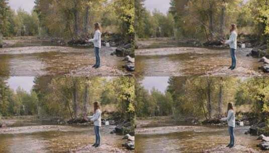 女孩在小溪边钓鱼高清在线视频素材下载