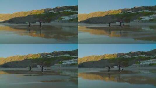 女孩拿着冲浪板在沙滩上奔跑高清在线视频素材下载