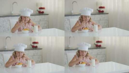 小女孩带着厨师帽开心的吃冰淇淋高清在线视频素材下载