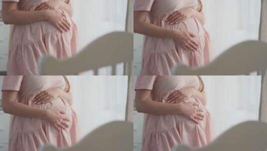 美丽孕妇轻轻抚摸着肚子里的宝宝高清在线视频素材下载