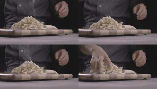 4K厨师往面条上撒面粉特写高清在线视频素材下载