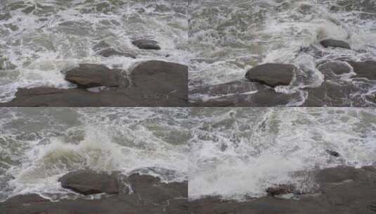 海浪拍打岩石浑浊海水冲刷礁石浪花阴天大海高清在线视频素材下载
