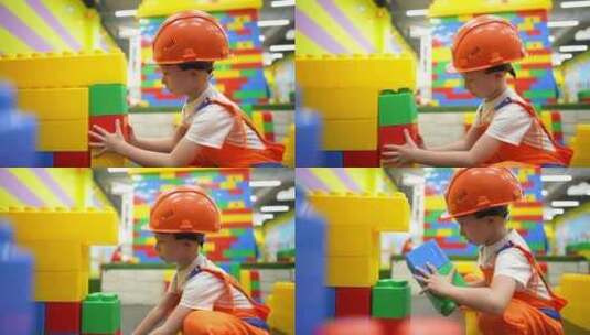 小男孩用建筑砖建造房子高清在线视频素材下载