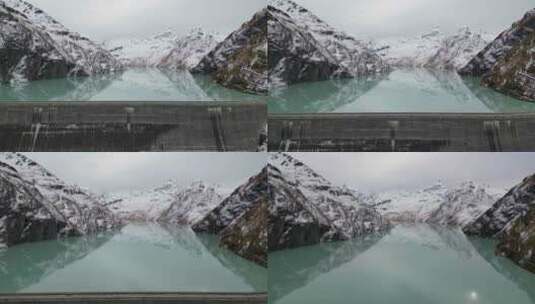 令人惊叹的无人机镜头在阿尔卑斯湖、水坝和被崎岖的穆包围的巨大阿尔卑斯水库上空高清在线视频素材下载