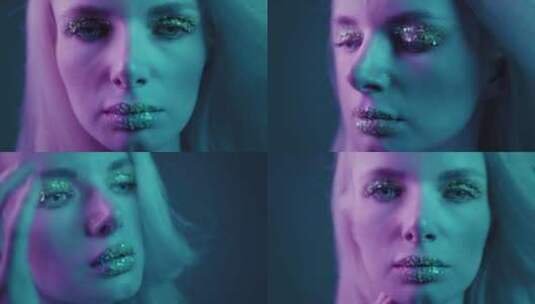 特写是一个美丽的金发女孩在霓虹灯工作室一高清在线视频素材下载