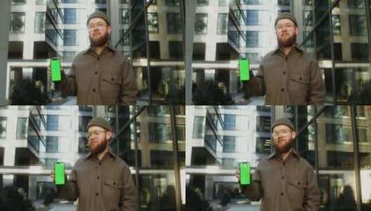 男人举着绿屏手机高清在线视频素材下载