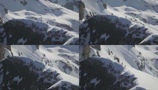 航拍在雪山山脊上行走的登山者高清在线视频素材下载