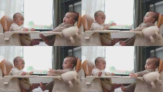 双胞胎宝宝坐在椅子里玩耍高清在线视频素材下载