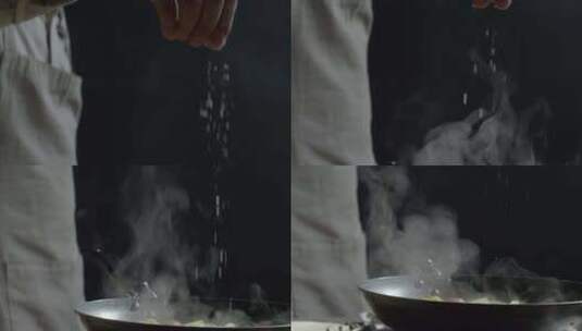 米其林厨师缓慢地撒盐在锅里制作美食高清在线视频素材下载