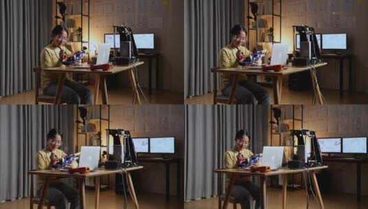青少年亚洲女孩修复一个机器人手在家高清在线视频素材下载