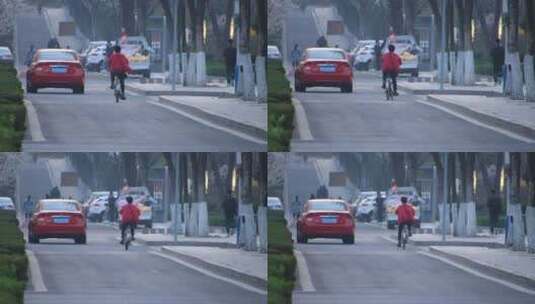 城市道路的车辆和骑自行的人高清在线视频素材下载