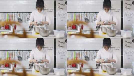 年轻女性烘培师在厨房做西点甜点高清在线视频素材下载
