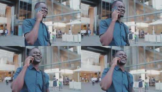 非洲黑人青年走在成都街头开心打电话高清在线视频素材下载