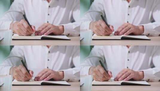 一个男人在笔记本上书写高清在线视频素材下载