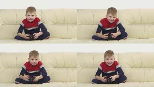 男孩在沙发上玩电子游戏高清在线视频素材下载